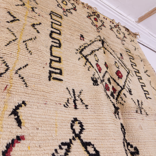 Nomadic Symbols” – Vintage Moroccan Rug with Tribal Motifs and Minimalist Palette